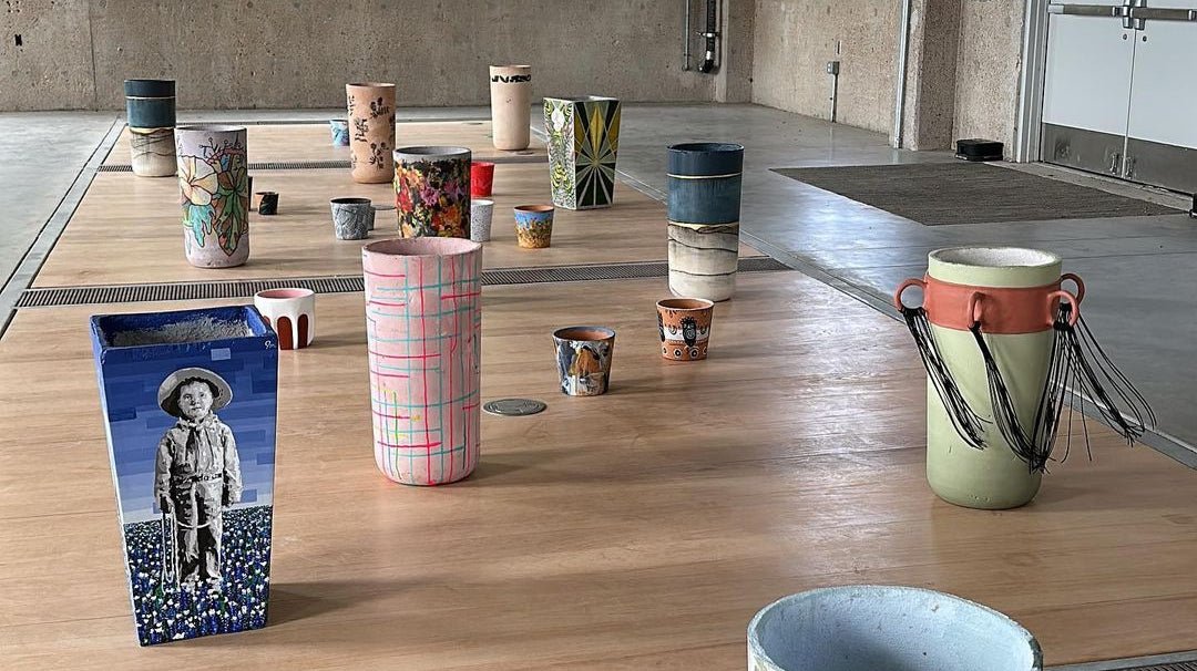 Image of multiple painted Concretti Designs Aster and Willow planters in an art gallery space