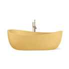Hawaii freestanding concrete bathtub with wave-inspired design shown from front angle in a bold golden-yellow shade known as Mustard.