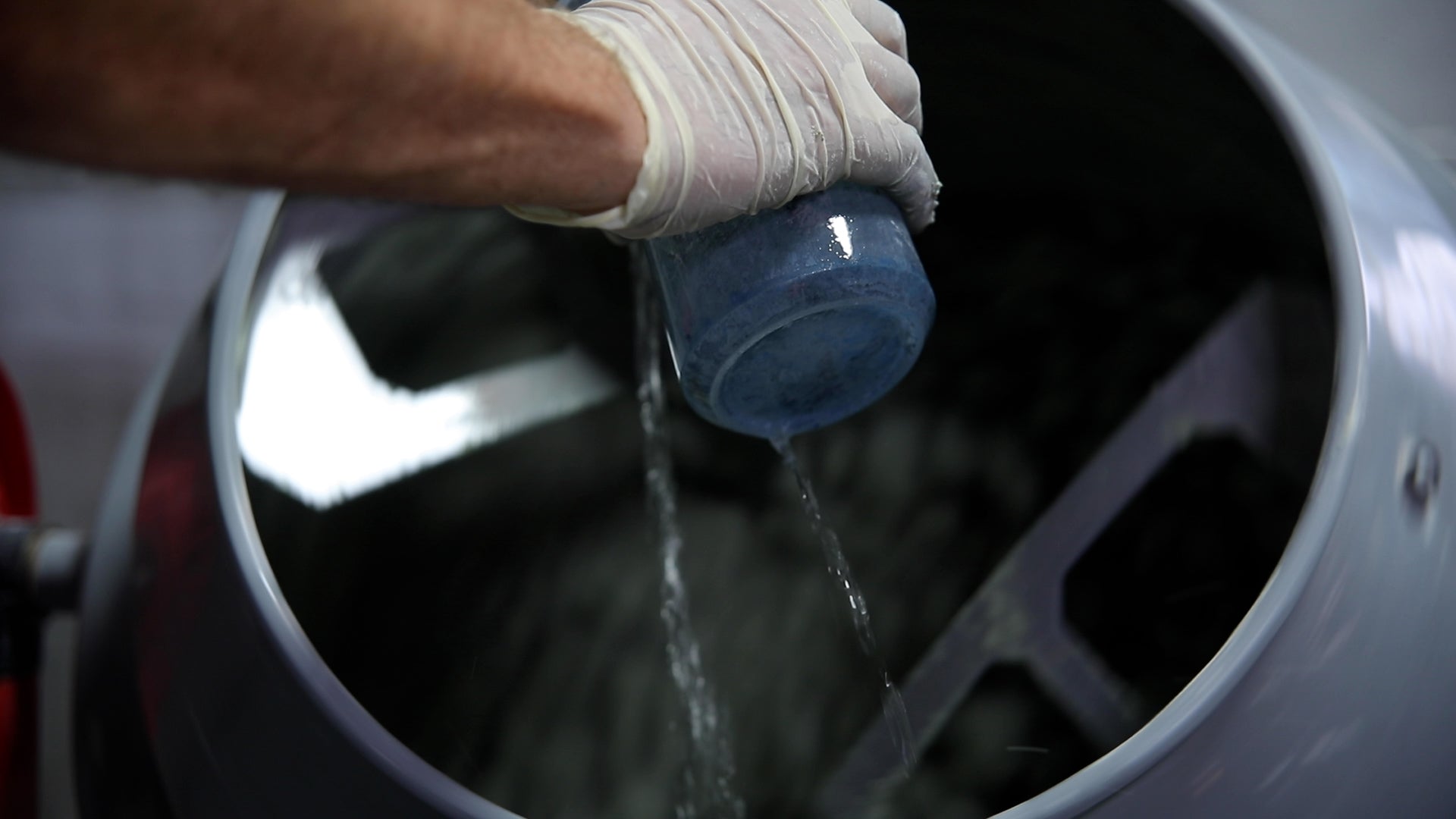 Pouring water in concrete mixer