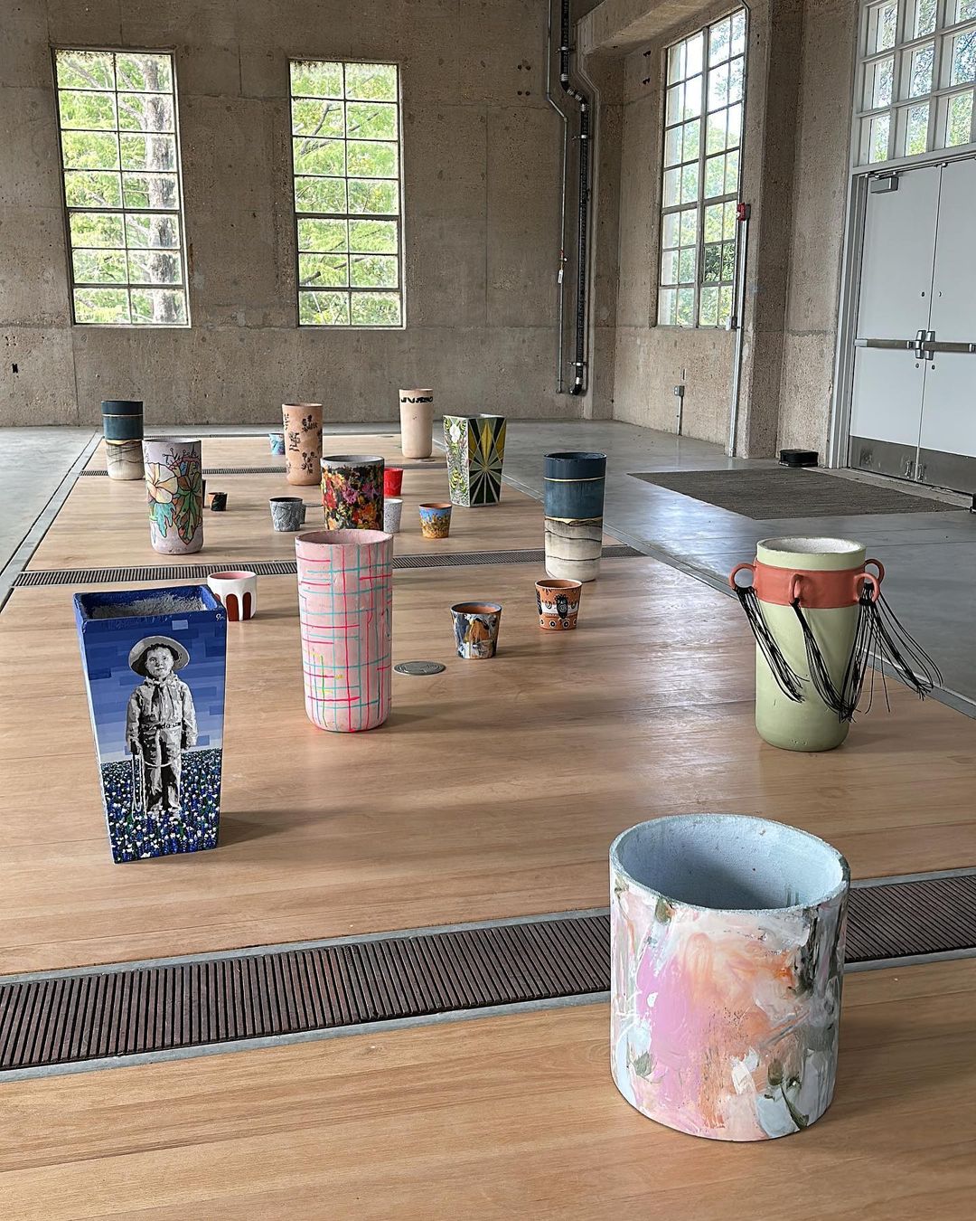 Image of multiple painted Concretti Designs Aster and Willow planters in an art gallery space